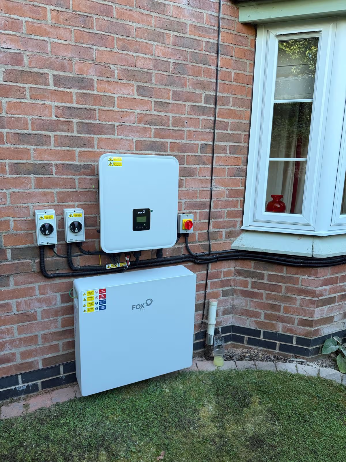 Fox ESS inverter and battery storage installed neatly on a house wall